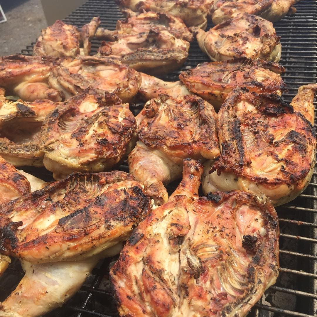 Grilled bone-in chicken on the catering grill at a Mansard off-site event