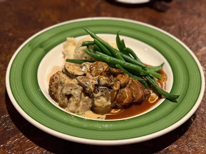 Pan-seared almond-crusted chicken with mashed potatoes and green beans