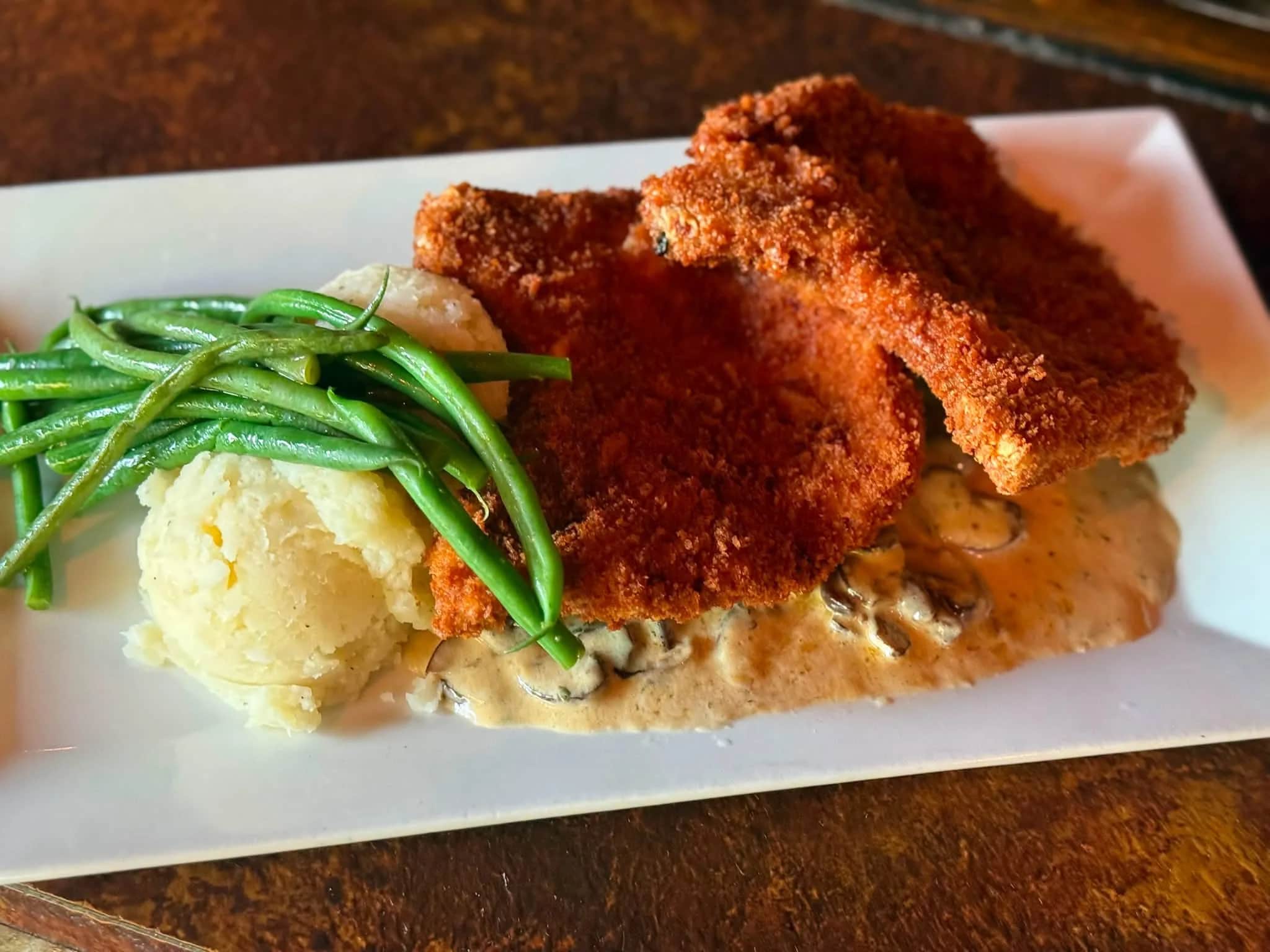 Panko-crusted pork chops over creamed cremini mushrooms with haricot vert and whipped potatoes at The Mansard Inn
