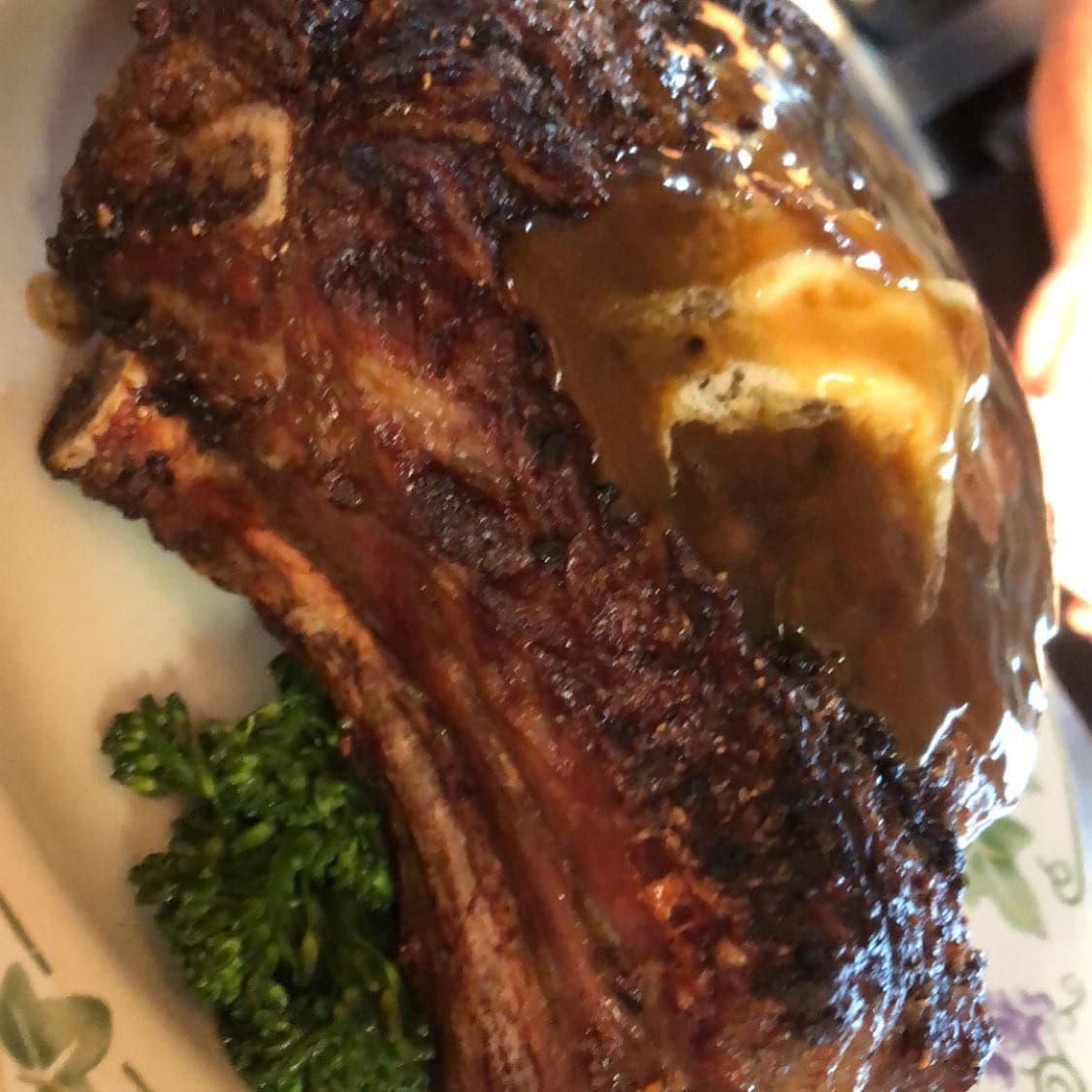 A massive char-grilled bone-in ribeye finished with pan sauce and parsley at The Mansard